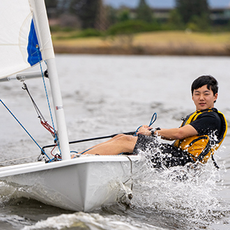 young man racing on shoreline lake