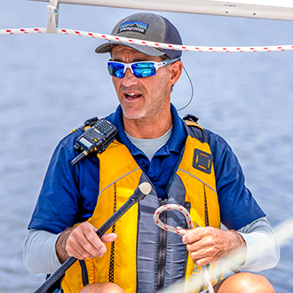 A man training counselors in the CIT program at shoreline lake.