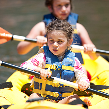 Two girls in a kayak boat.
