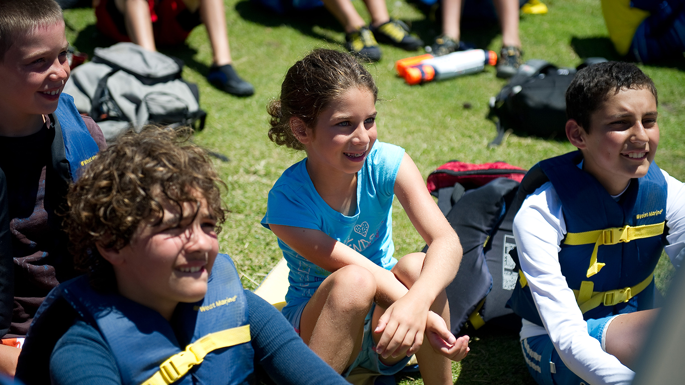 A group of kids listening to instruction
