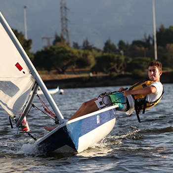 A young man steering a laser performanceboat