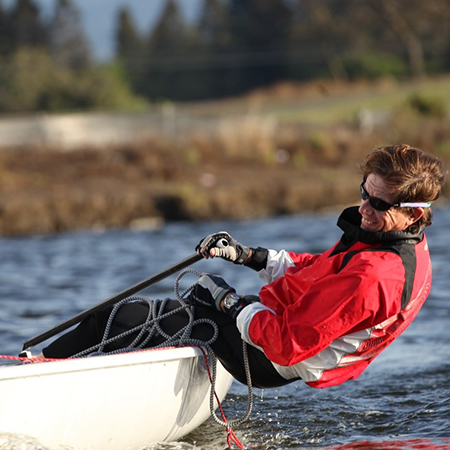 A man leaning out of his boat.