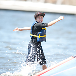 A boy making waves with his board