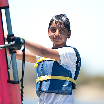 A young boy on a windsurf board