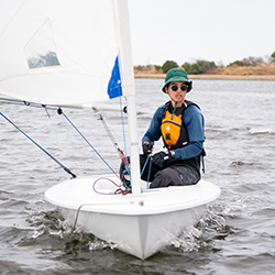 A man wearing sunglasses in a sailboat