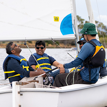 A group of men in a boat with their instructor