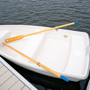 A row boat with wooden paddles