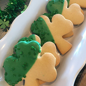 Some four leaf clover cookies on a platter