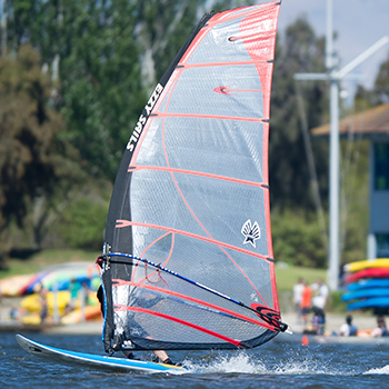 A person windsuring hidden behind the sail.